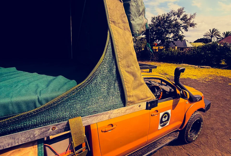 Open rooftop tent and sleeping area above an Eagle Overland Hilux