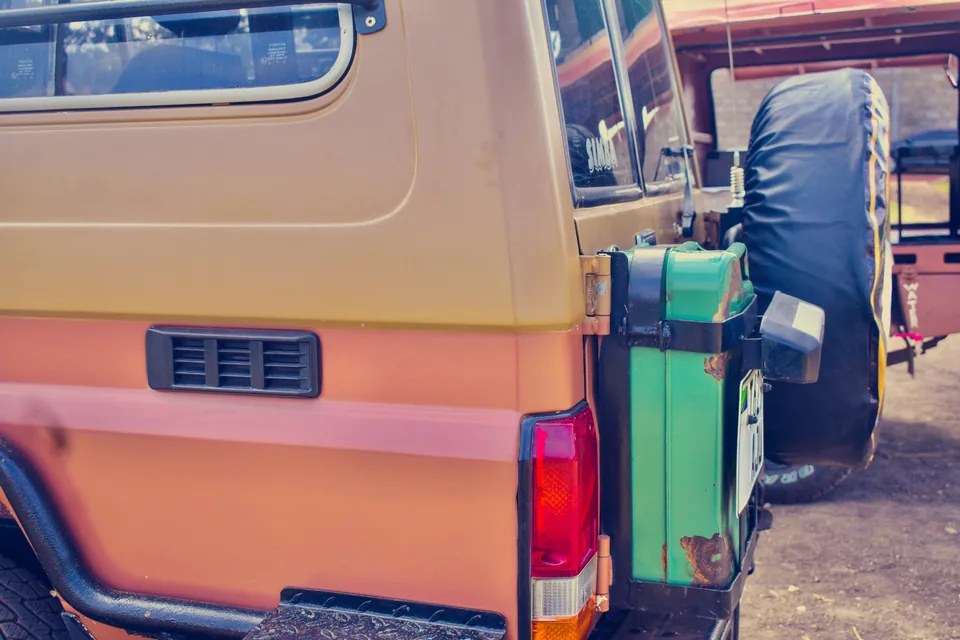Jerry can and covered spare tyre mounted at the rear of a Land Cruiser